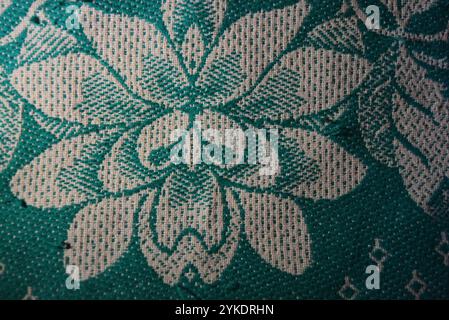 Things, objects, backgrounds made of dense natural fabrics of green color with white flowers and white threads. Stock Photo