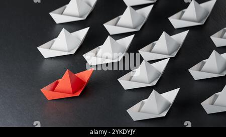 Red paper origami boat have individual direction from unique white boats in different way. Business strategy and opportunity concept.3D rendering on b Stock Photo