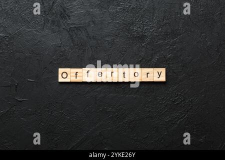 offertory word written on wood block. offertory text on table, concept. Stock Photo