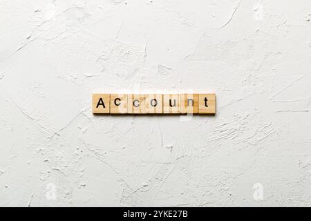 Account word written on wood block. Account text on cement table for your desing, concept. Stock Photo