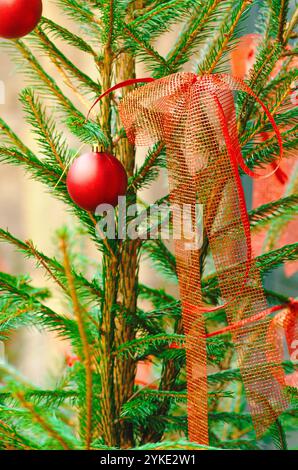Christmas tree decorated with bright red balls and red ribbons, background for Christmas concept. Stock Photo