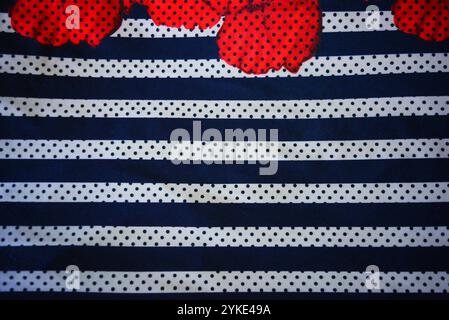 Things, objects, backgrounds made of dense synthetic fabrics of gray color with white and blue stripes, white and blue polka dots. Stock Photo