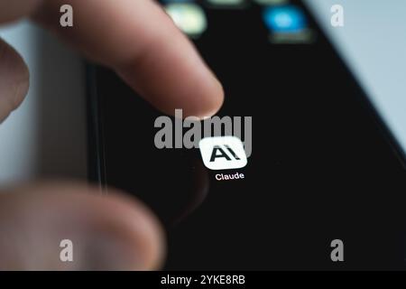 Person using Claude AI app smartphone. Large language model developed by Anthropic. Close up view Stock Photo