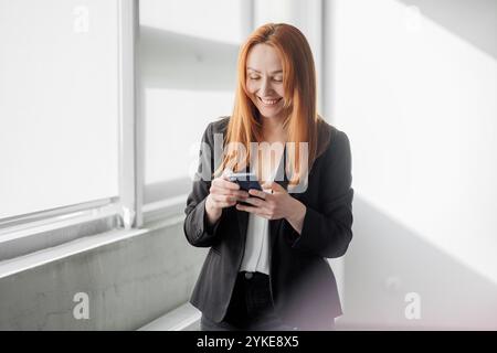 Businesswoman Using Smartphone Indoors Stock Photo