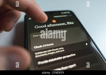 Person using Claude AI app smartphone. Large language model developed by Anthropic. Close up view Stock Photo