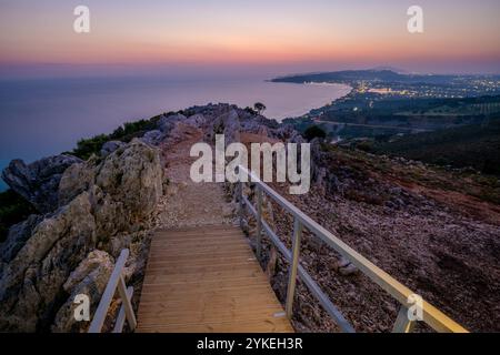 Sunrise over the island of Zakhyntos from a vantage point on the rocks Stock Photo