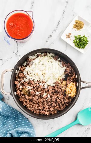 Ground beef and onions cooking in a pan with spices and garlic Stock Photo