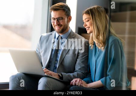 Business professionals collaborating on a project in a modern office. Team of coworkers sharing idea Stock Photo