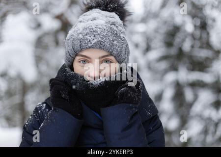 Portrait of young woman in a snow park drinks tea Stock Photo - Alamy