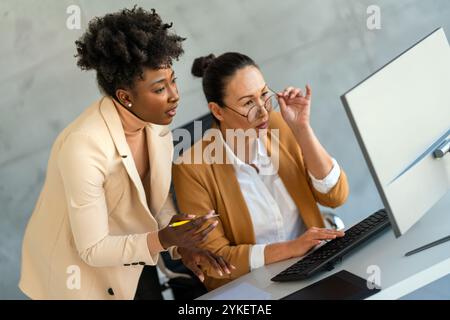 Mixed team of software engineers brainstorming ideas. Diverse app developers collaborating as group Stock Photo
