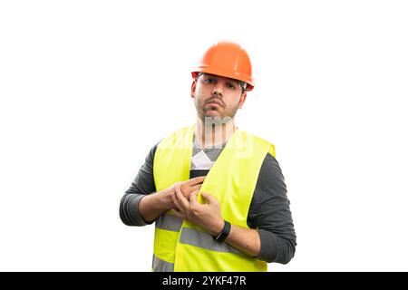 Serious constructor trades workman hiding cash money salary and leather wallet in safety fluorescent work vest isolated on white studio background Stock Photo