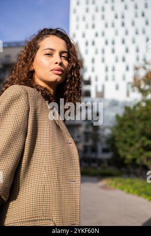 Confidence shines in this portrait of a Brazilian businesswoman, dressed smartly in a blazer, standing confidently in an urban environment Stock Photo
