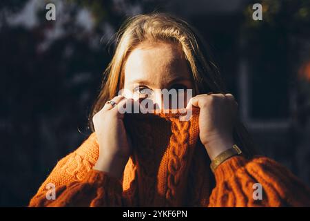 Blonde hides her face behind her blonde hair Stock Photo - Alamy