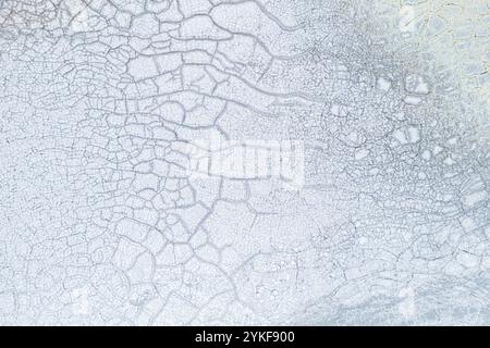 A high resolution image showcasing the intricate patterns of dried and cracked mud, ideal for background or texture use in design projects. Stock Photo