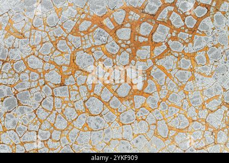 Detailed view of cracked mud textures in earth tones, showcasing natural patterns and arid climate effects. Stock Photo