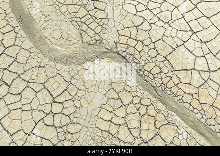 An aerial view of a dried out terrain with intricate patterns of cracked mud. Stock Photo
