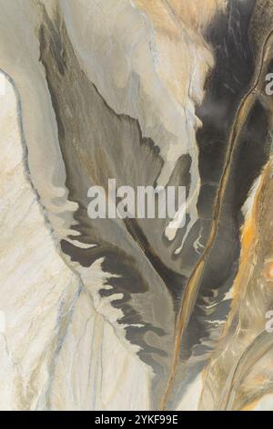 An aerial view of Riotinto showcasing abstract forms and earthy textures in shades of brown, gray, and beige The natural patterns resemble an abstract Stock Photo