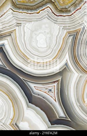 Vibrant close-up of Laguna Lace agate from Mexico, highlighting its distinct multi-colored bands in earthy tones Features captivating concentric layer Stock Photo