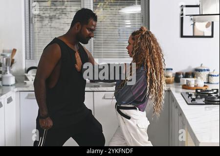 Multiethnic Couple Of Dancers Dancing In The Kitchen Stock Photo