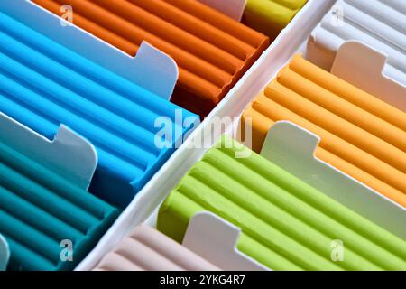 Artistic plastic clay for modeling in a box. Children multicolored plasticine modeled for learning craft. Art of modeling material close up. Stock Photo