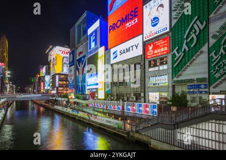 This is a night view of the billboards and neon lights in the Dotonbori shopping district along the riverside on June 27, 2023 in Osaka, Japan Stock Photo