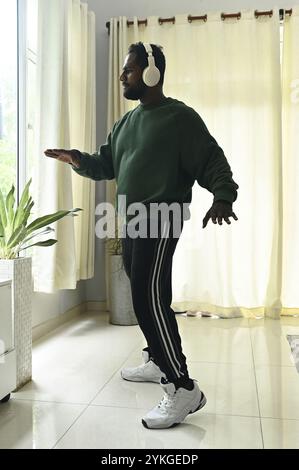 Man In Headphones Dancing At Home Stock Photo