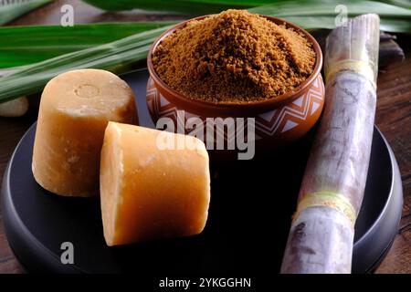 Jaggery powder with jaggery cubes. Jaggery is used as an ingredient in sweet and savoury dishes in the cuisines of India. Stock Photo
