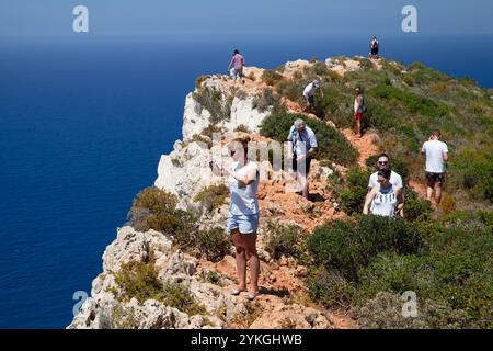 Zakynthos, Greece - August 20, 2016: Tourists takes photos at rocks of Navagio bay, Greece. Zakynthos island natural landmark Stock Photo