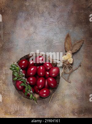 Painted eggs in a wooden bowl, red, painted madder dye, powder from the roots of endro, with onion husks, top view, Easter, Georgia, Asia Stock Photo