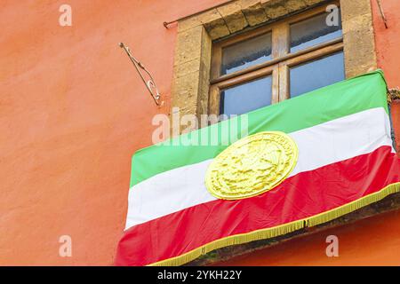 Mexican flag green white red hanging on building in the center of Mexico City in Mexico Stock Photo