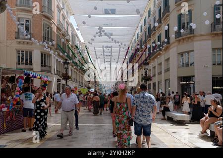 Bustling Calle Larios adorned with vibrant decorations during the Málaga August Fair Stock Photo