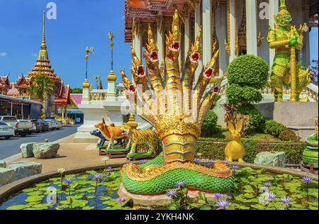 Golden and green dragons dragonfish statues in amazing colorful Wat Don Mueang Phra Arramluang buddhist temple in Bangkok Thailand Stock Photo