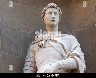 Florence, ITALY- November 11, 2024: The statue of Saint George the Warrior 1416-1417 by Donatello in the external niches of the church of Orsanmichele Stock Photo