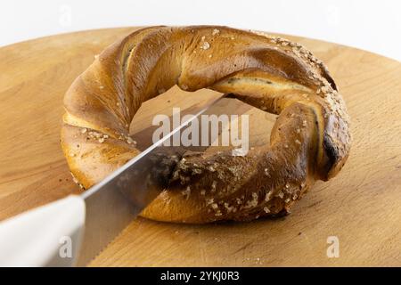 International pretzel holiday, pretzel days, Krakow pretzels, cutting pretzels, pretzels on a white background, on a cutting board Stock Photo