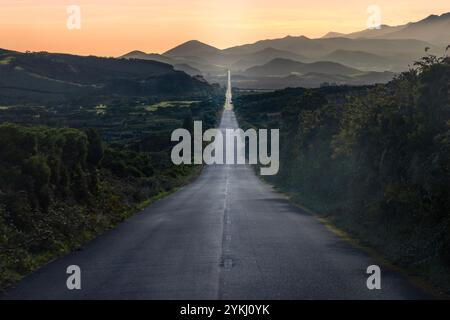 A road trip along Portugal’s longest straight road with a view of Pico Mountain and the mountain range, Azores. Stock Photo