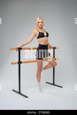 Young woman practicing ballet at a dance studio during a rehearsal session Stock Photo