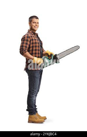 Young male worker holding a chainsaw isolated on white background Stock Photo