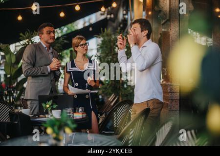 Businesspeople meeting outdoors discussing strategies and analyzing reports for business growth in a casual setting with teamwork and collaboration in Stock Photo