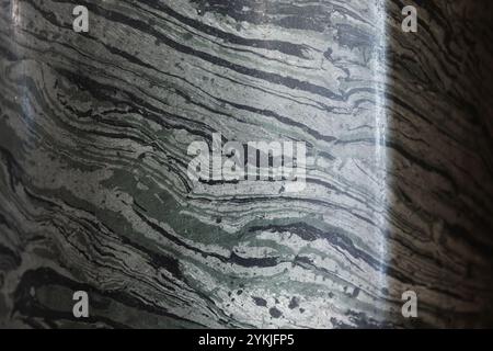 Abstract background photo texture of deep green marble pillar with shadow and glare, close up, front view Stock Photo