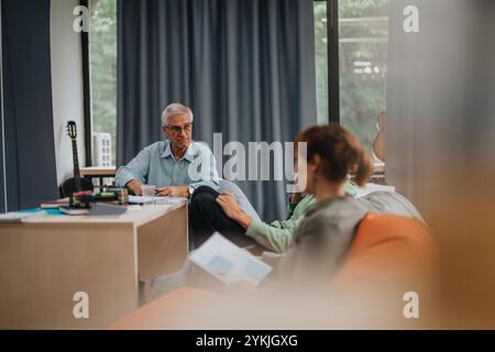 Professor engaging with students in an informal meeting Stock Photo