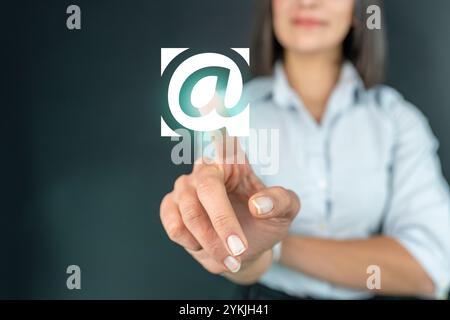 Businesswoman touch email icon on hand, communication concept Stock Photo