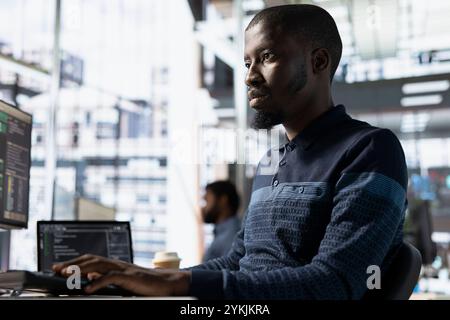 Engineer utilizing cloud computing resources and platforms to train and deploy large scale machine learning models. Man monitoring and maintaining company systems, ensuring their reliability Stock Photo