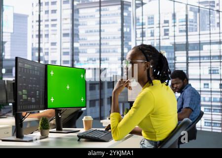 Developer using chroma key computer, testing machine learning company software to minimize occurrence of bugs. IT professional writing code on isolated screen PC to reduce errors Stock Photo