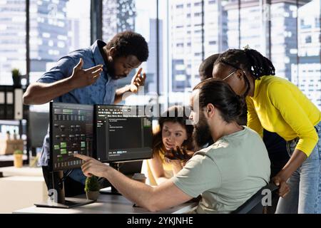 Coworkers doing brainstorming, conducting experiments and tests to optimize machine learning models for performance and accuracy. Colleagues gathered in office to analyze complex AI data Stock Photo