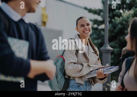 Group of students studying outdoors in park setting on sunny day Stock Photo