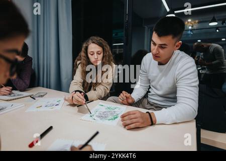 Students collaborating on an art project in a creative classroom setting Stock Photo