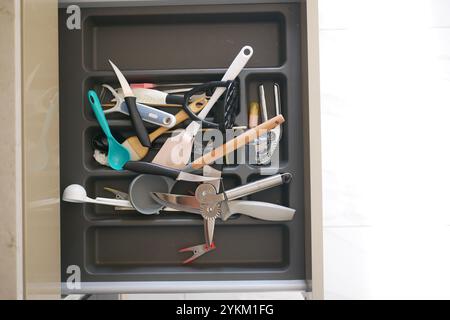 Close up of messy kitchen utensil drawer. Stock Photo