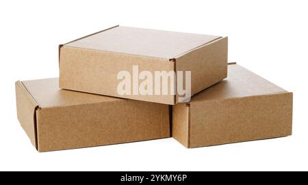 Stacked brown cardboard boxes in various sizes arranged on a white background Stock Photo