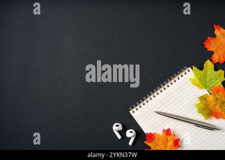 Top view of notebook and ballpoint pen on dark grey background Stock Photo