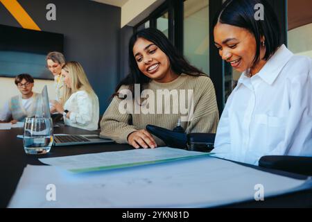 Undergrad students in a classroom collaborate on a college project, showcasing teamwork and diverse perspectives in a modern educational environment. Stock Photo